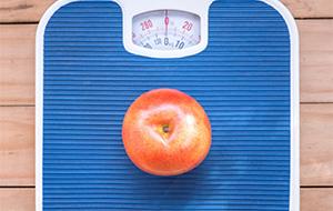 scale with apple sitting on it